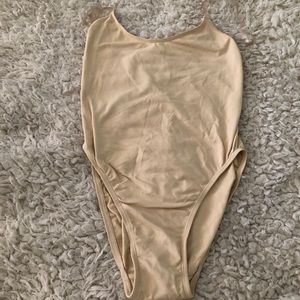 Nude body suit with clear straps